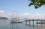 Bar Harbour. Sailing ship with the Porcupine Islands in the distance.